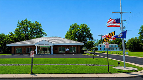 PRFC Office Building with a yard arm out front with three flags